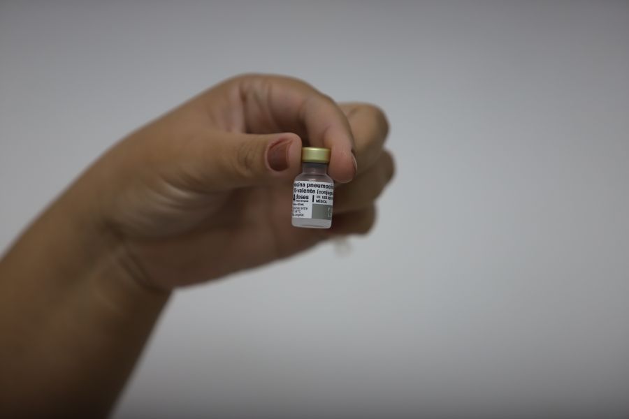Hand hält eine Durchstechflasche mit MMR-Impfstoff