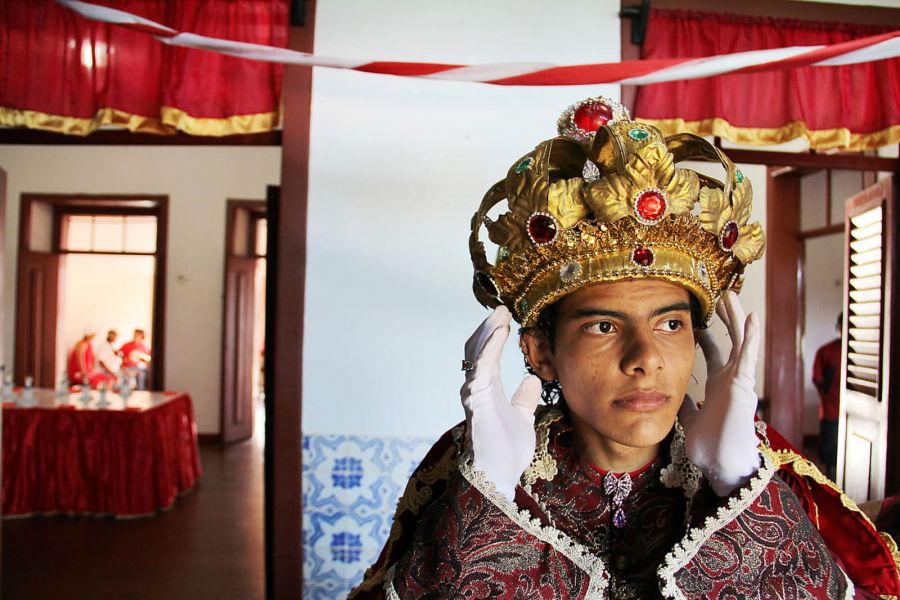 Homem vestido de roupa de rei e com coroa na cabeça